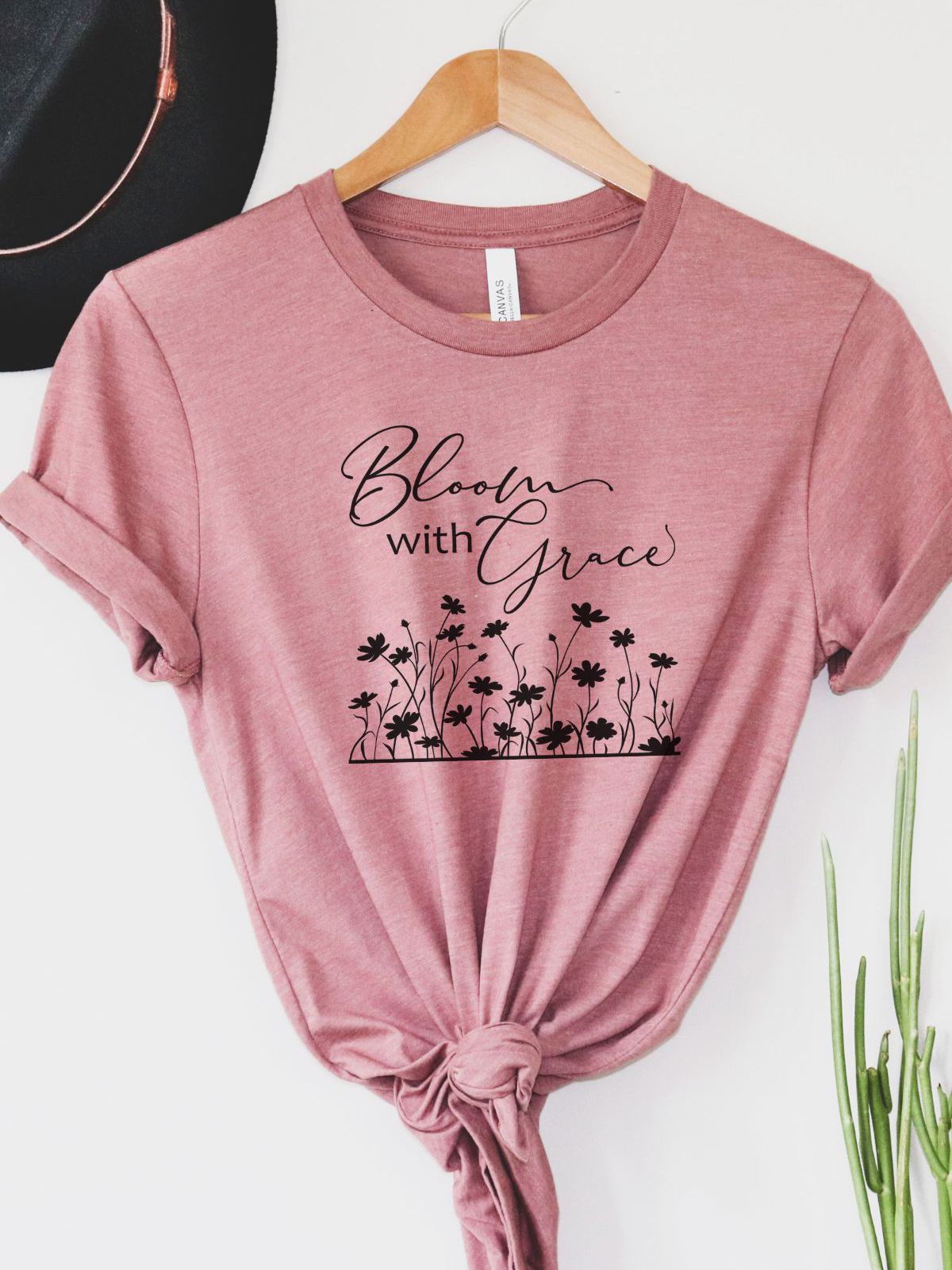 Pink t-shirt with Bloom with Grace text and floral design