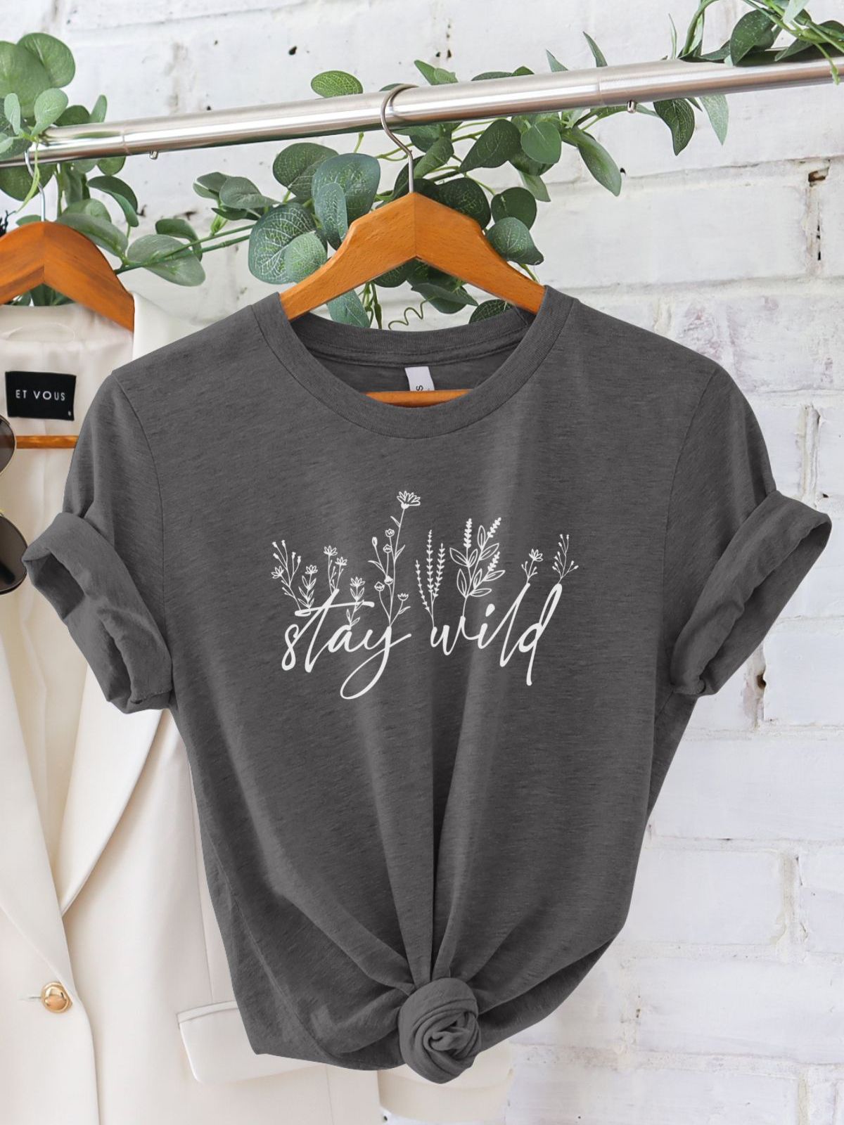 dark gray t-shirt with stay wild text and floral design