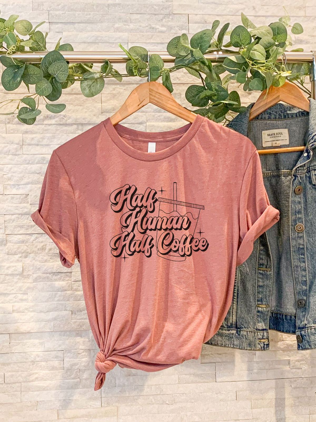 Half Human Half Coffee t-shirt hanging on a rack