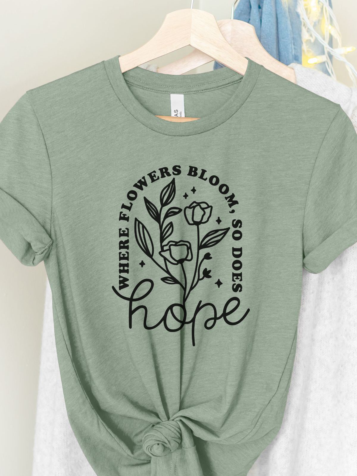 green t-shirt with floral design and hope text