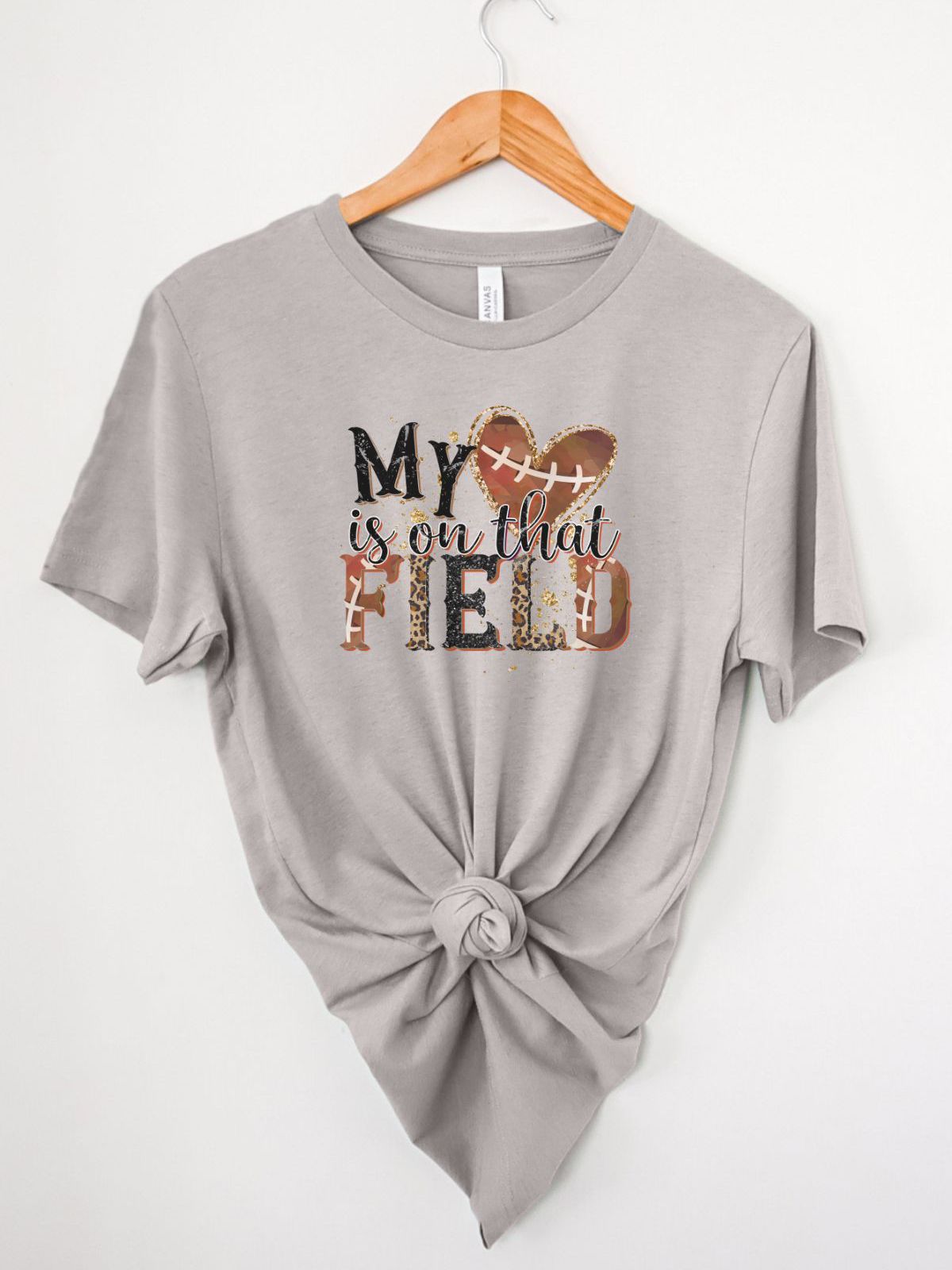 Gray t-shirt with My Heart is on that Field design hanging