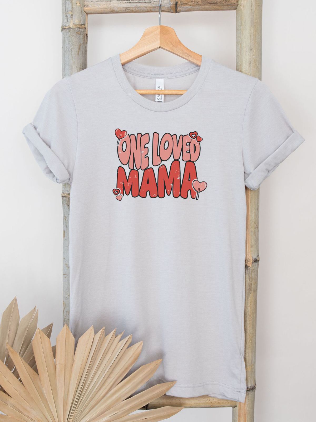 one loved mama tshirt hanging on display