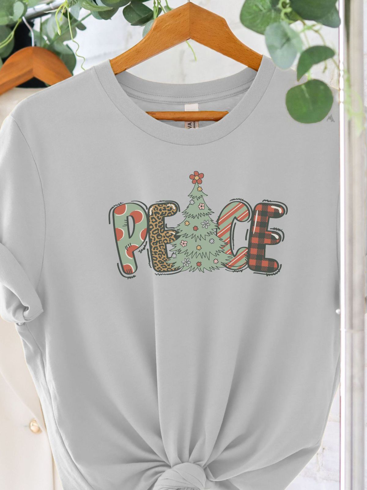 peace christmas design t-shirt on hanger