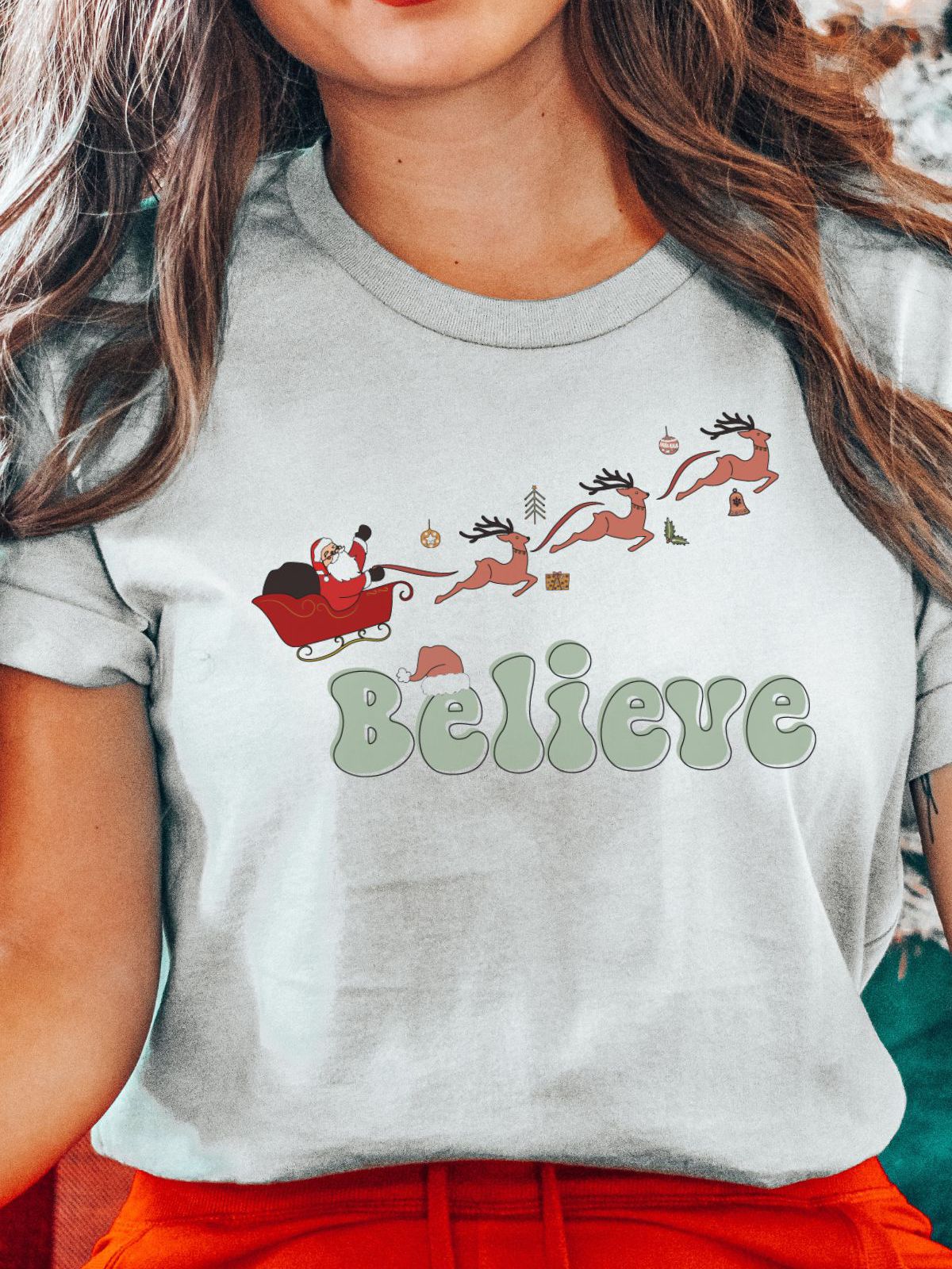 woman wearing Believe Christmas t-shirt with Santa and reindeer
