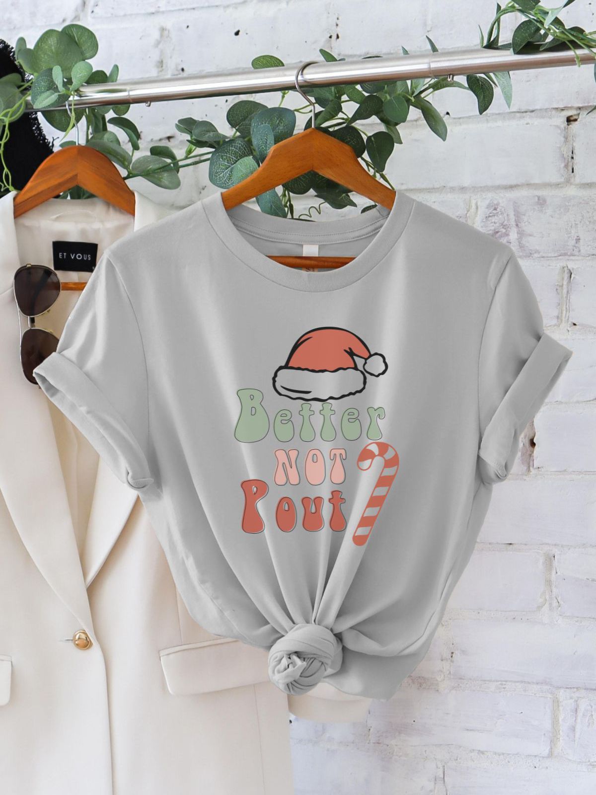 Gray t-shirt with Better Not Pout design hanging on rack