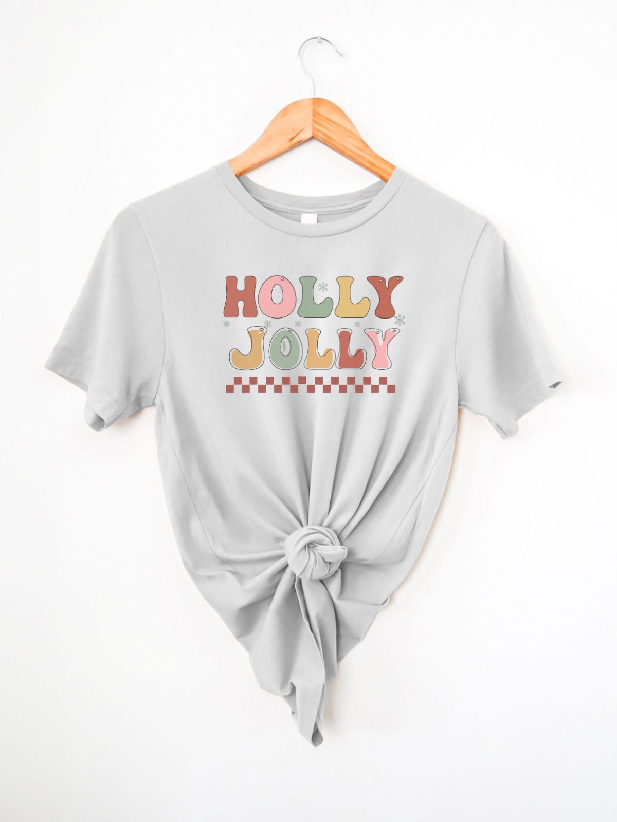 Holly Jolly graphic t-shirt on a hanger