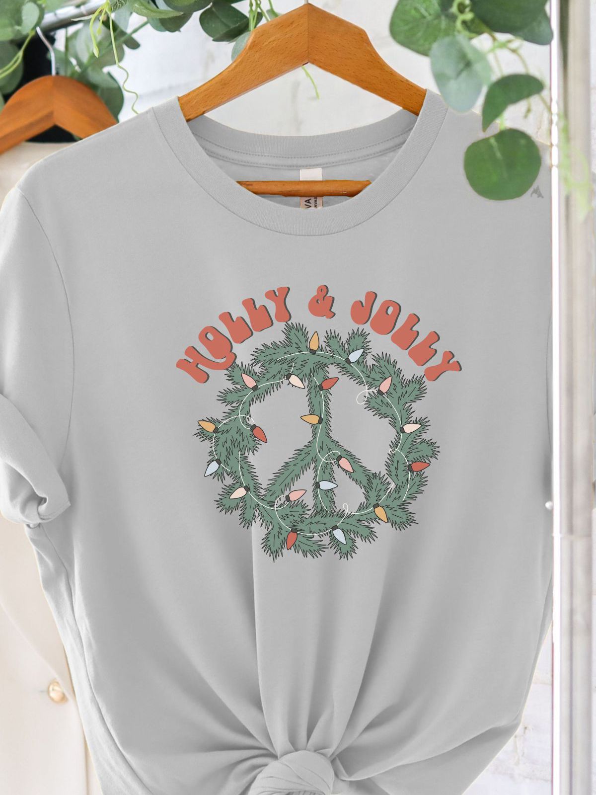 gray tee with peace symbol wreath and holly jolly text
