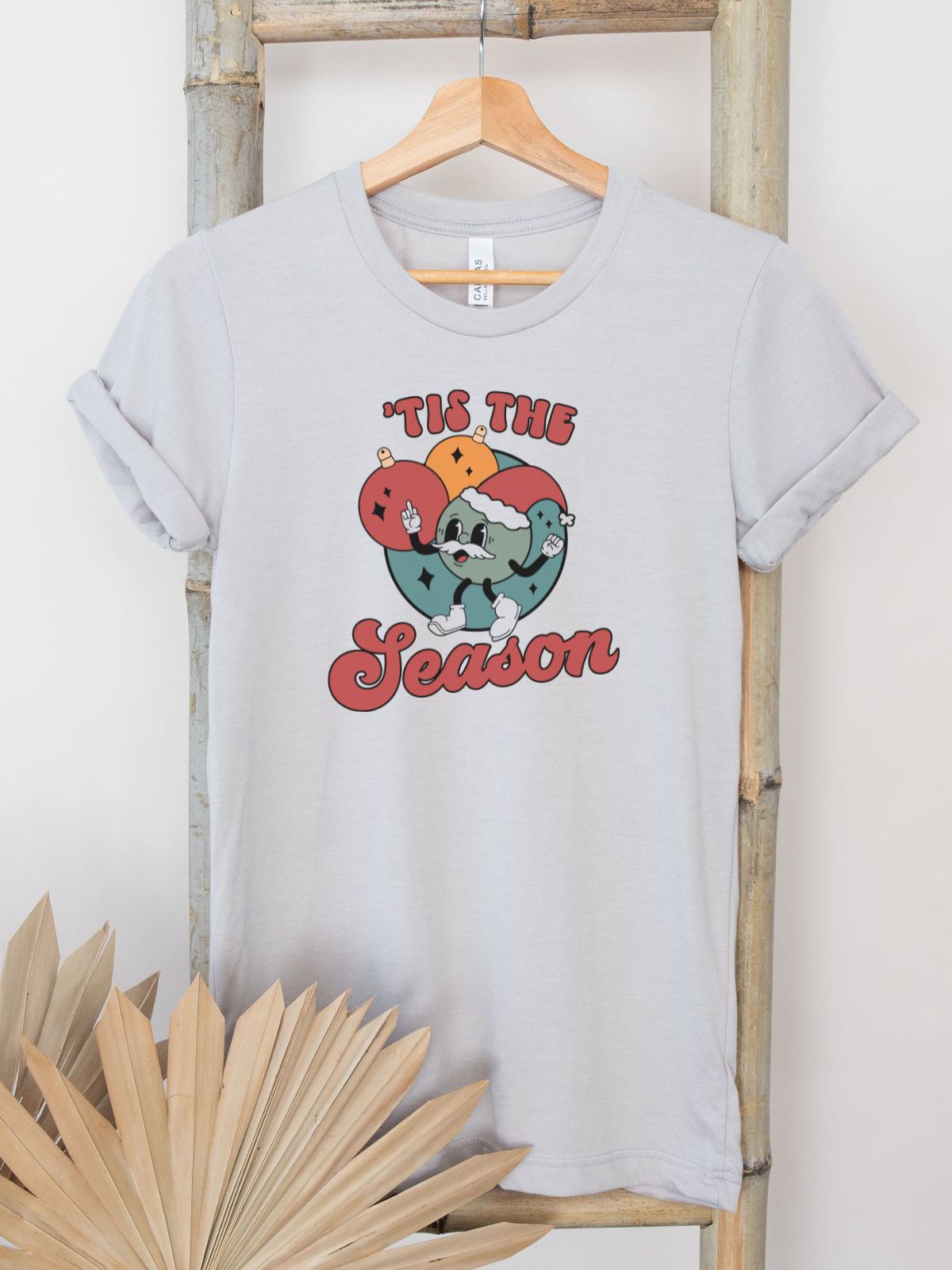 Tis the Season graphic t-shirt on hanger